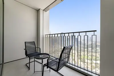 two chairs and a table in front of a window at Silkhaus Elegant 1BDR in Downtown Views II in Dubai