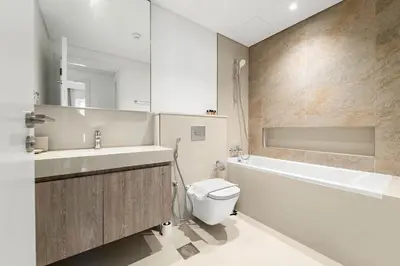 a bathroom with a sink and a toilet and a bath tub at Silkhaus Elegant 1BDR in Downtown Views II in Dubai