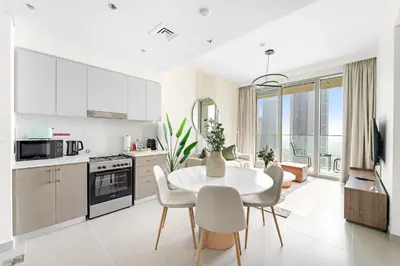 a kitchen and dining room with a table and chairs at Silkhaus Beautiful 1 BDR in Heart of Downtown in Dubai