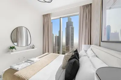 a bedroom with a large bed with a large window at Silkhaus Beautiful 1 BDR in Heart of Downtown in Dubai