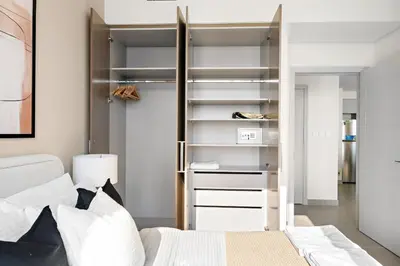 a bedroom with a bed and a closet at Silkhaus Beautiful 1 BDR in Heart of Downtown in Dubai