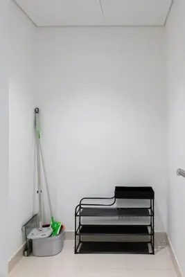 a white room with a bed and a mop at Stylish studio with storage room in hotel l Fits 2 in Dubai