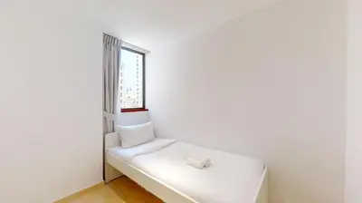a white bed in a room with a window at Vacationer I Premium 3 Bedroom Apartment I Steps Away from JBR Beach in Dubai