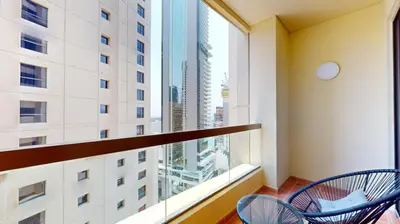 a balcony with two chairs and a large window at Vacationer I Premium 3 Bedroom Apartment I Steps Away from JBR Beach in Dubai
