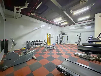 a room with a gym with a treadmill and weights at DreamLike Full Pool & Marina View Apartment Dubai in Dubai