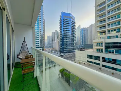 a balcony with a view of a city with tall buildings at DreamLike Full Pool & Marina View Apartment Dubai in Dubai