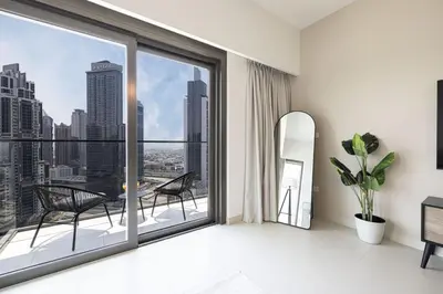 a room with a large window with a view of the city at LUXE | 2BR | Sea & City View | 5 Min to Dubai Mall in Dubai