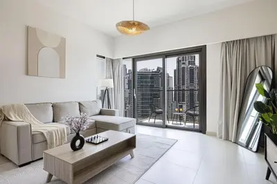 a living room with a couch and a table at LUXE | 2BR | Sea & City View | 5 Min to Dubai Mall in Dubai