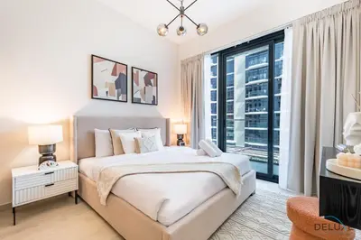 a bedroom with a bed and a large window at Stunning 1BR Apartment in Azizi Riviera 42, Al Merkadh by Deluxe Holiday Homes in Dubai