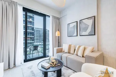 a living room with a couch and a table at Stunning 1BR Apartment in Azizi Riviera 42, Al Merkadh by Deluxe Holiday Homes in Dubai