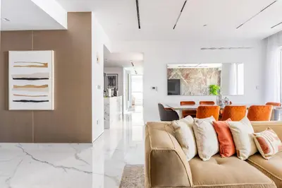 a living room with a couch and a table at Seaside Elegance - NEW Luxury 3-Bedroom Apt in JBR in Dubai