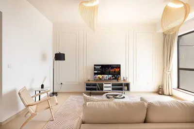 a living room with a couch and a tv at Dubai Eye & Sea View, 1-min walk to JBR Beach, Luxurious Beach Retreat! in Dubai