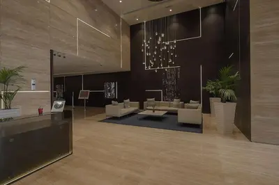 a lobby with couches and plants in a building at Dubai Modern Apartment l Sleeps 4 l 2 Baths in Dubai