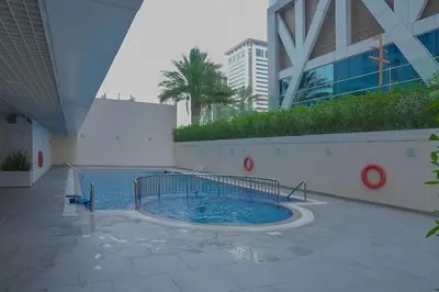 a swimming pool in the middle of a building at Dubai Modern Apartment l Sleeps 4 l 2 Baths in Dubai