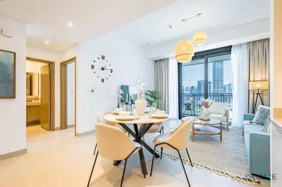 a dining room and living room with a table and chairs at Alluring 1BR with Marina View at 5242 Tower 2 Dubai Marina by Deluxe Holiday Homes in Dubai