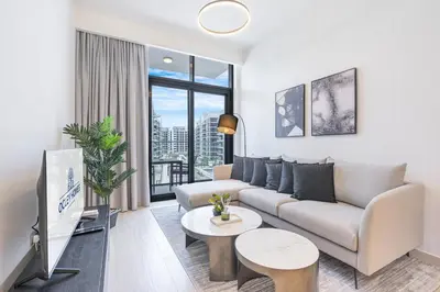 a living room with a couch and a tv at Charming 2BR Home with Elegant Interior in Dubai