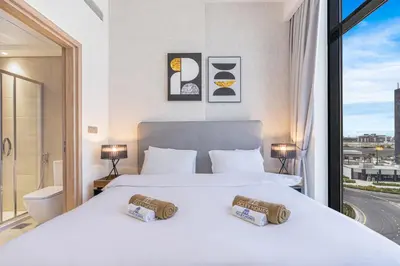 a hotel room with two beds and a window at Charming 2BR Home with Elegant Interior in Dubai