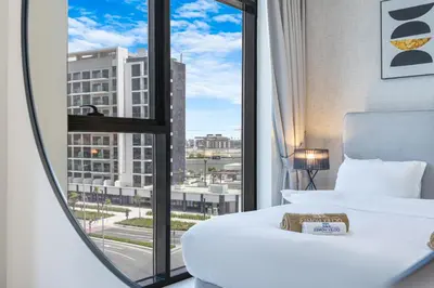 a hotel room with a bed and a large window at Charming 2BR Home with Elegant Interior in Dubai