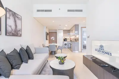a living room with a couch and a table at Charming 2BR Home with Elegant Interior in Dubai