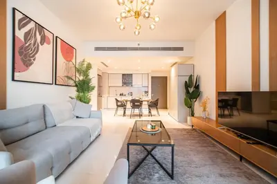 a living room with a couch and a table at SettlerHomes - Seaside Lux Marina near Private Beach in Dubai