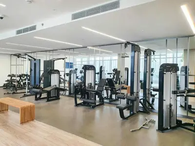 a gym with a lot of treadmills and machines at SettlerHomes - Seaside Lux Marina near Private Beach in Dubai