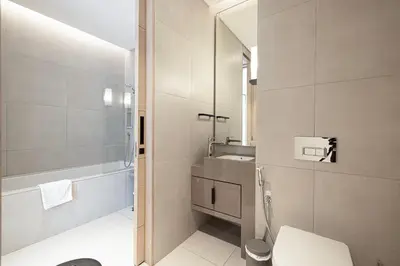 a bathroom with a toilet and a sink and a mirror at Address Beach Resort JBR - 1 BR in Dubai