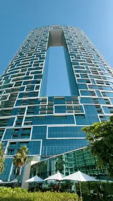a tall building with some umbrellas in front of it at Address Beach Resort JBR - 1 BR in Dubai