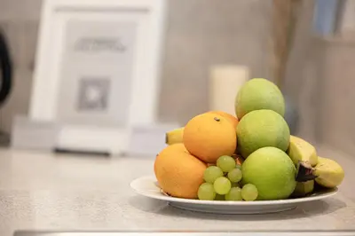 a bowl of fruit on a plate on a counter at Incredible Burj Khalifa Views, Next to Dubai Mall in Dubai