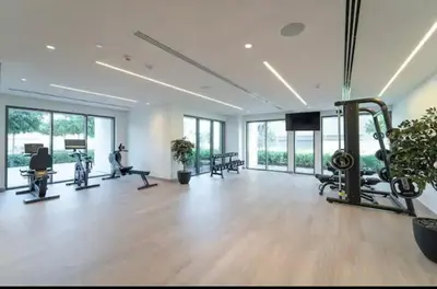 a gym with treadmills and machines in a room with windows at Incredible Burj Khalifa Views, Next to Dubai Mall in Dubai