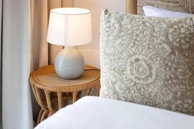 a lamp sitting on a table next to a bed at Incredible Burj Khalifa Views, Next to Dubai Mall in Dubai