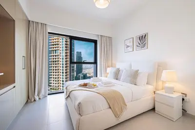 a bedroom with a large bed and a large window at Incredible Burj Khalifa Views, Next to Dubai Mall in Dubai