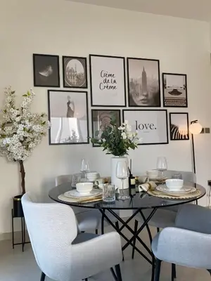 a dining room with a table and pictures on the wall at Incredible Burj Khalifa Views, Next to Dubai Mall in Dubai