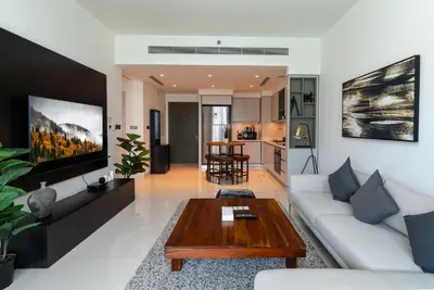 a living room with a white couch and a coffee table at 2 BR Private Beach Access & Marina View in Dubai