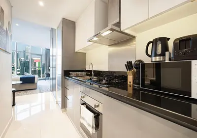 a kitchen with a stove and a view of the city at Lux Studio in Downtown - Damac Maison Prive - Near Burj Khalifa in Dubai