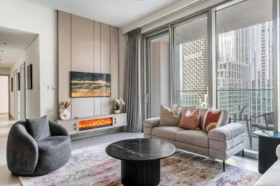 a living room with a couch and a fireplace at the London Condo - Forte Downtown Dubai in Dubai