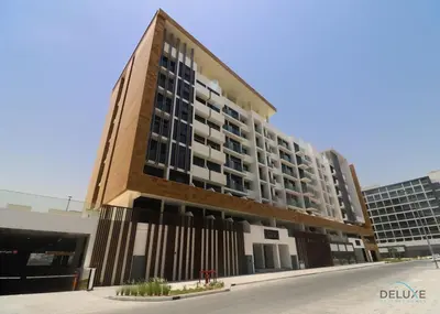 an office building with a tall building at Inviting 1BR Apartment in Azizi Riviera 32, Al Merkadh by Deluxe Holiday Homes in Dubai
