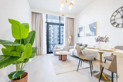 a living room with a couch and a table at Inviting 1BR Apartment in Azizi Riviera 32, Al Merkadh by Deluxe Holiday Homes in Dubai