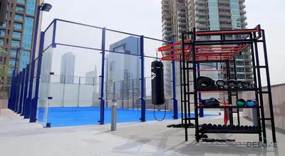 a fence on the side of a building with a pool at Chic 1BR in The Residence at Marina Gate 2, Dubai Marina by Deluxe Holiday Homes in Dubai