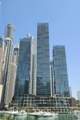 a group of tall buildings with boats in the water at Chic 1BR in The Residence at Marina Gate 2, Dubai Marina by Deluxe Holiday Homes in Dubai
