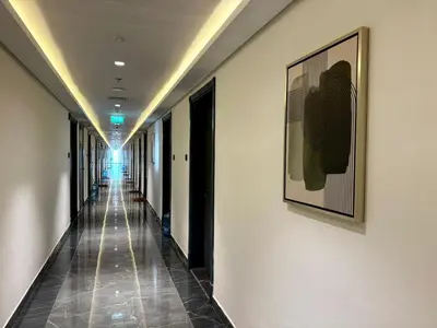 a hallway of a building with a picture on the wall at Cozy Studio with sun terrace in Dubai