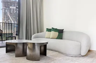 a living room with a couch and a table at 5 min to Metro - New 1 Bed in Business Bay in Dubai
