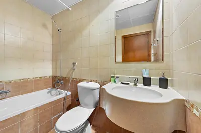 a bathroom with a sink and a toilet and a tub at StoneTree - Newly Furnished - Near Metro in Dubai