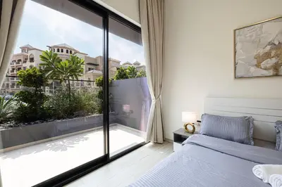 a bedroom with a bed and a large window at 1-Bed in Binghatti Crescent, Next to Circle Mall in Dubai
