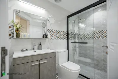 a bathroom with a shower and a toilet and a sink at Clever Guest 025 Dubai Gate 1 in Dubai