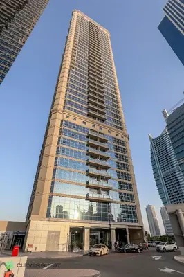 a tall building with cars parked in front of it at Clever Guest 025 Dubai Gate 1 in Dubai