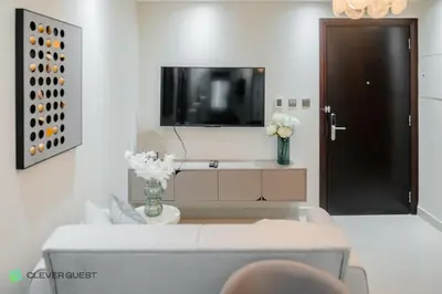 a living room with a couch and a tv at Clever Guest 025 Dubai Gate 1 in Dubai