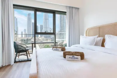 a hotel room with two beds and a large window at Stunning Renovated Home with Full Burj Khalifa View in Dubai
