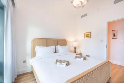 a bedroom with a large white bed with white pillows at Stunning Renovated Home with Full Burj Khalifa View in Dubai