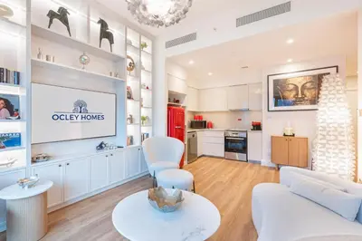 a living room with a couch and a table at Stunning Renovated Home with Full Burj Khalifa View in Dubai
