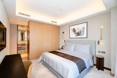 a hotel room with a large bed and a bathroom at Escape24 2BR in Address Opera with Skyline Views near Burj Khalifa in Dubai